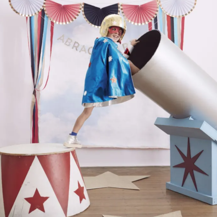 child wearing super hero costume in a circus setting 