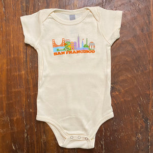 San Francisco icons picture above the words San Francisco on cream colored onesies