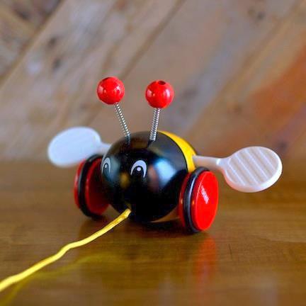 wooden bee pull toy with yellow string