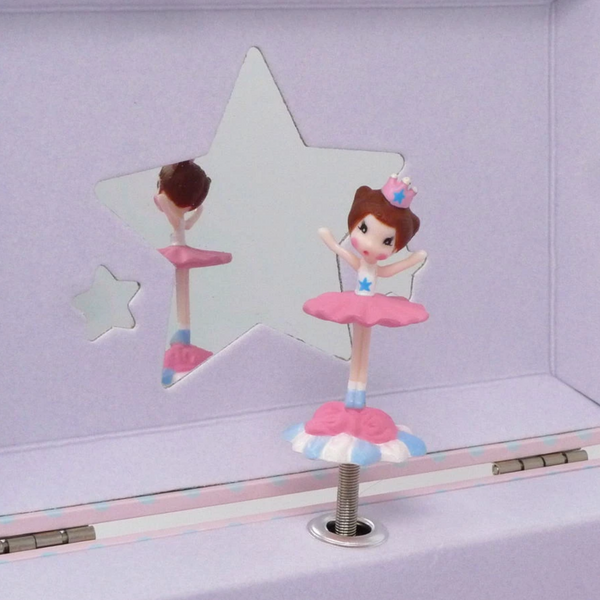 close up of spinning ballerina with star shaped mirrors behind her