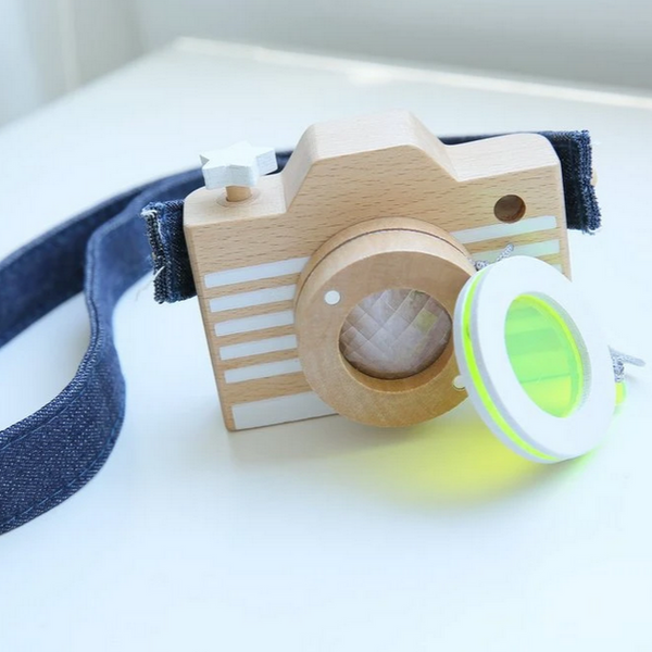 wooden camera with yellow lens off showing prism lens