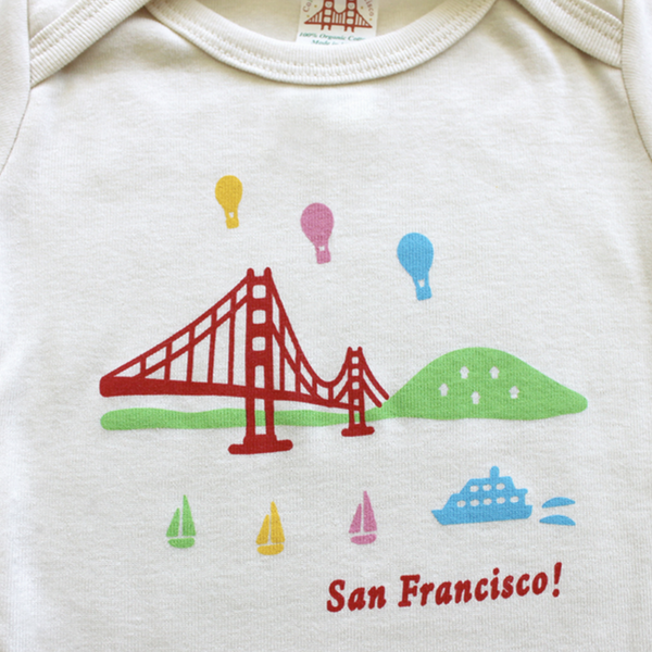 close up view of balloons and gg bridge on onesie