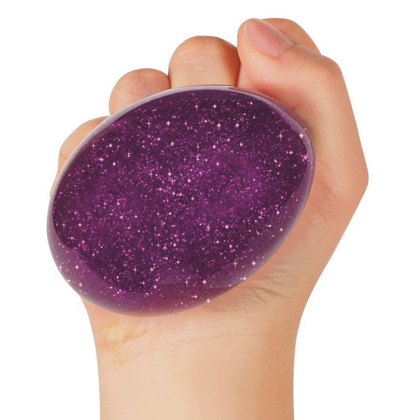 purple glittery nee doh ball being squeezed by a hand