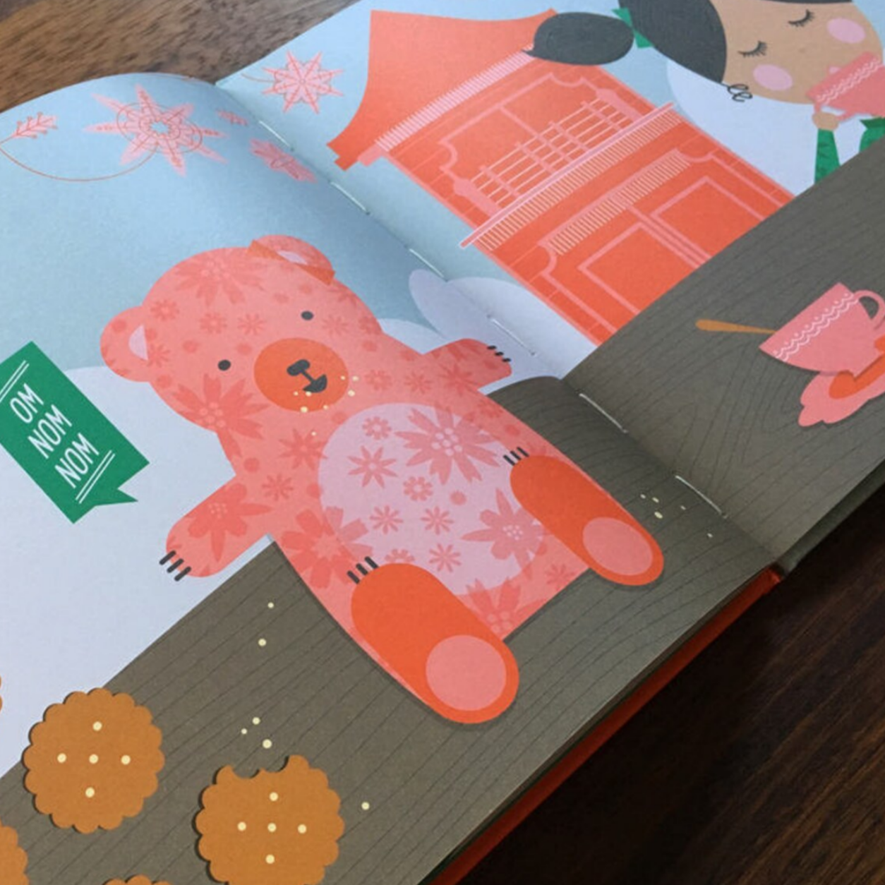 pages of book with teddy bear eating cookies and little girl sipping tea in China town