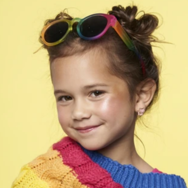 a girl wearing pink cat earings and sunglasses on her head