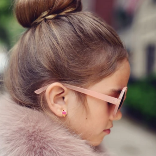 A little girl wearing the icecream earrings