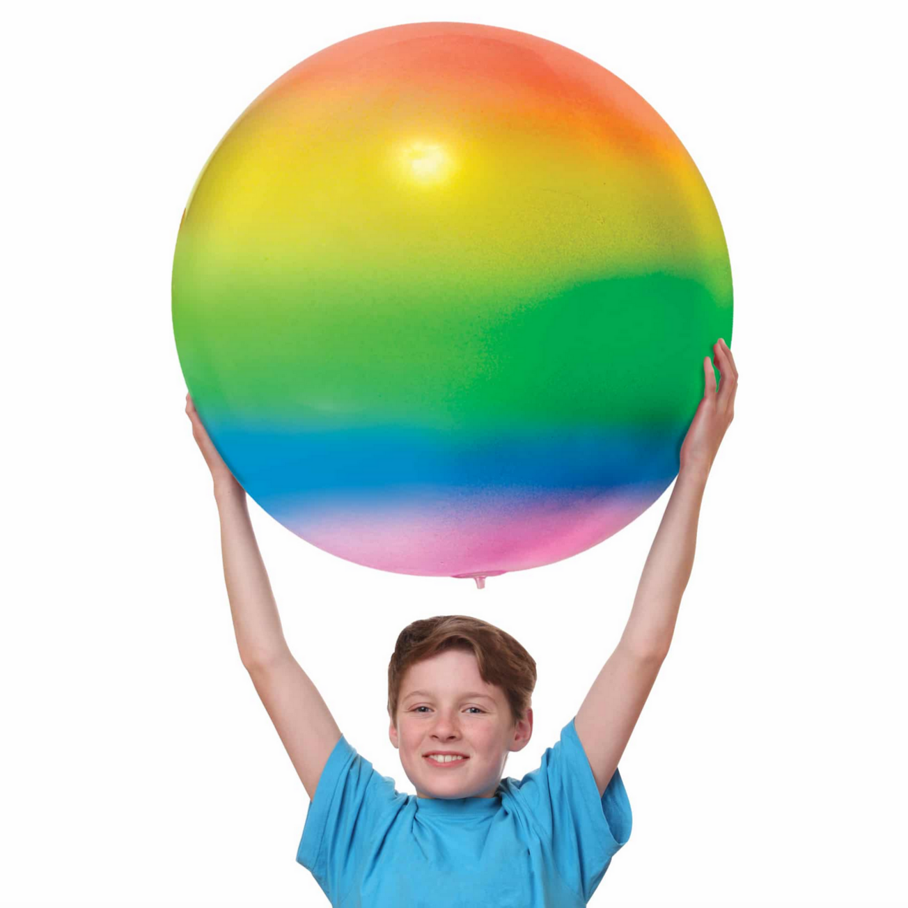 boy holding giant rainbow striped ball