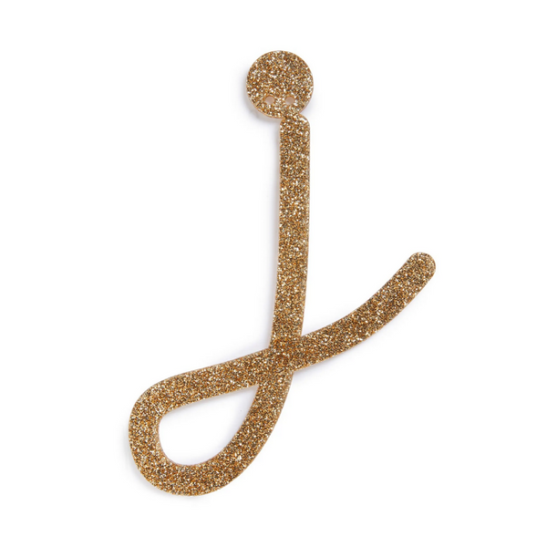 lowercase cursive j in gold acrylic with small holes to hang it.