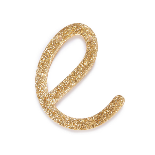lowercase cursive e in gold acrylic with small holes to hang it.