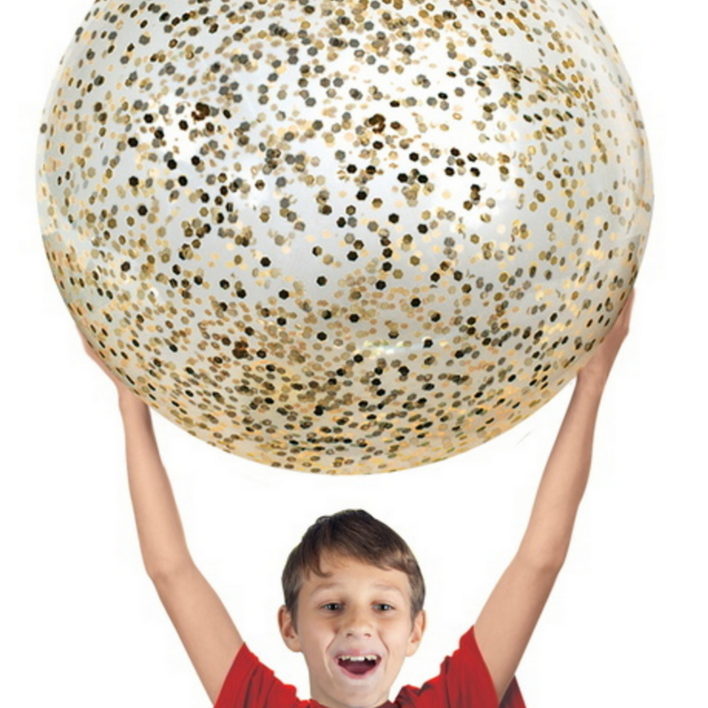 boy holding giant gold glittered ball above head