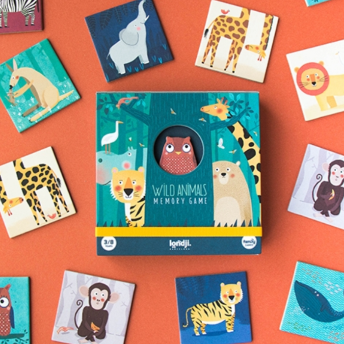 A collection of colorful playing cards laid out on a surface, featuring illustrations of various wild animals. The pack is named 'Wild Animals Memory Game'.