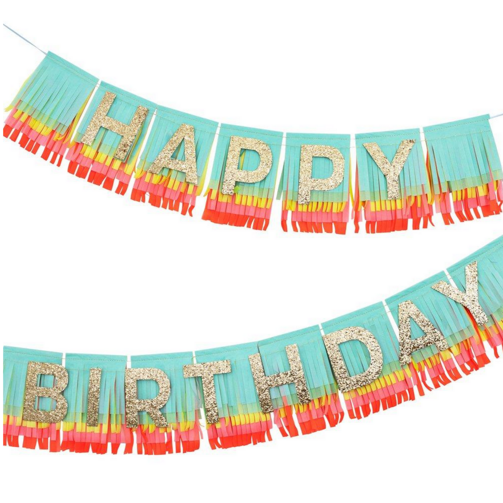 rainbow colored fringe garland with gold glittered Happy birthday letters on top