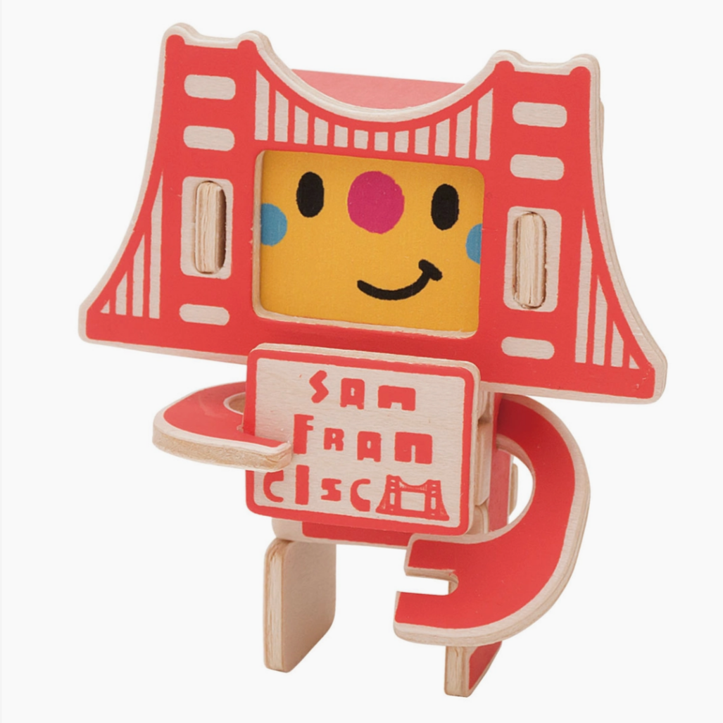 wooden figure of Golden gate Bridge holding San Francisco sign with a yellow face