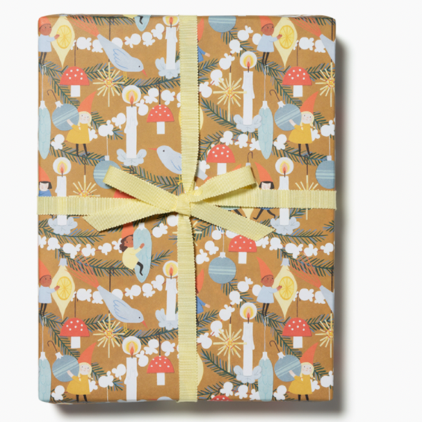gift wrapped in golden color paper with popcorn and pine garlands and ornaments and candles