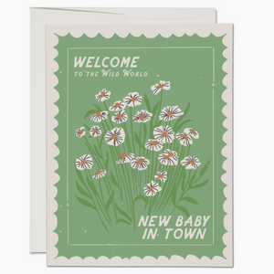 green card with white flowers that reads "welcome to the wild world new baby in town"