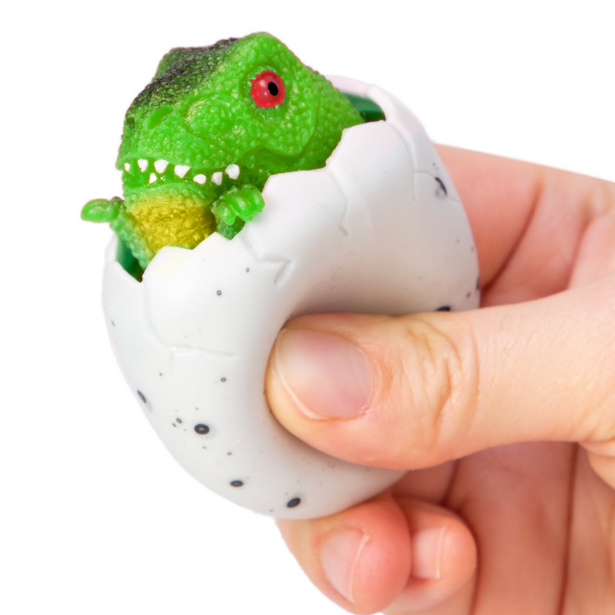 green baby dinosaur peeking out of egg that's being squeezed by a hand