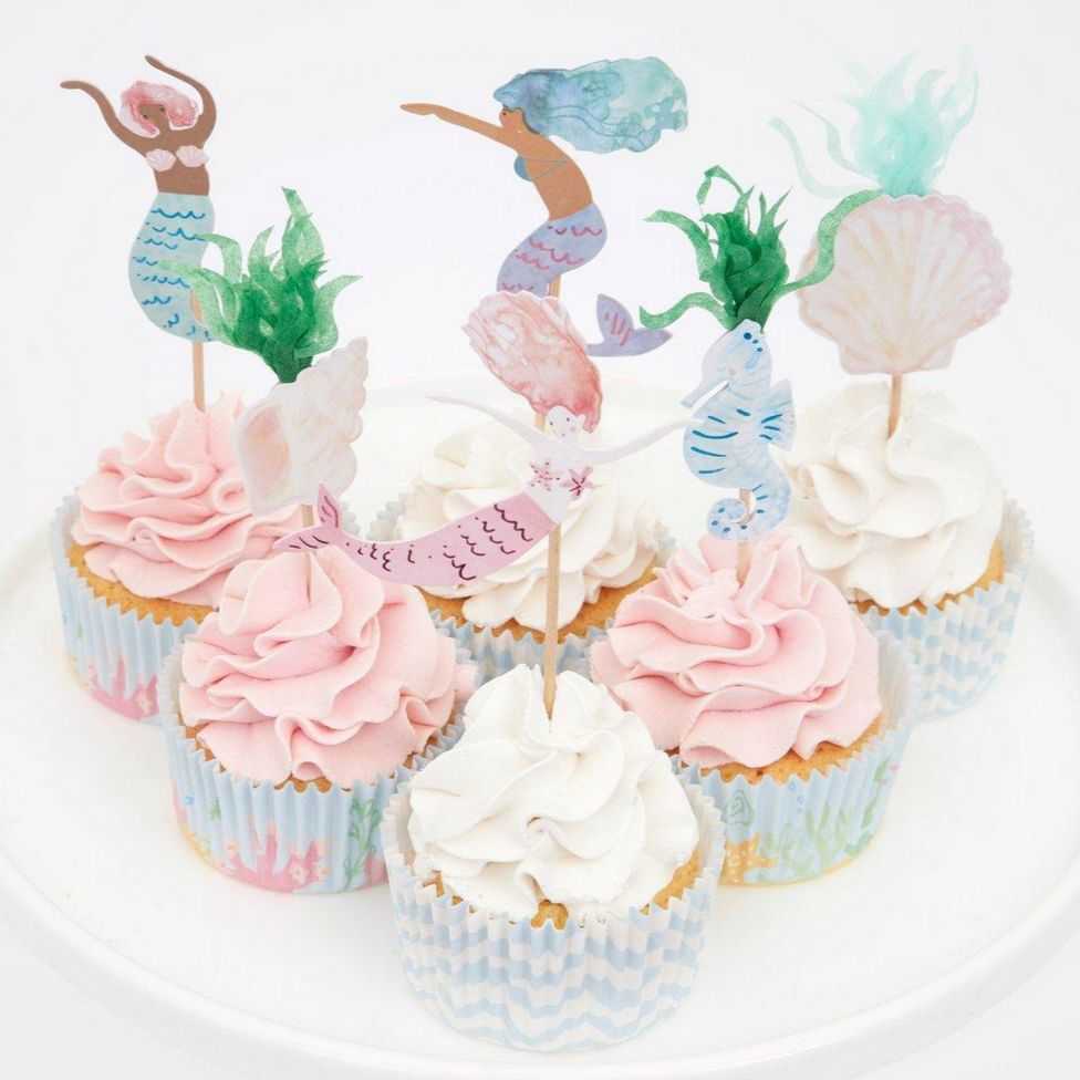 mermaid and shell toppers on pink and white cupcakes with water themed cupcake liners