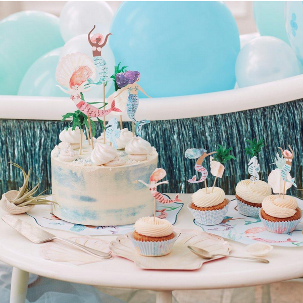 mermaid themed party with mermaid toppers on cupcakes and cake