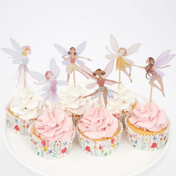 cupcakes with fairy toppers in them 