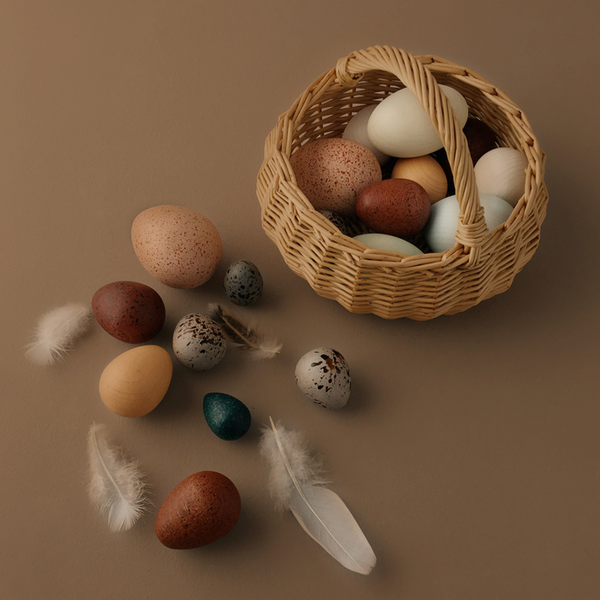 A Dozen Wooden Bird Eggs in a Basket