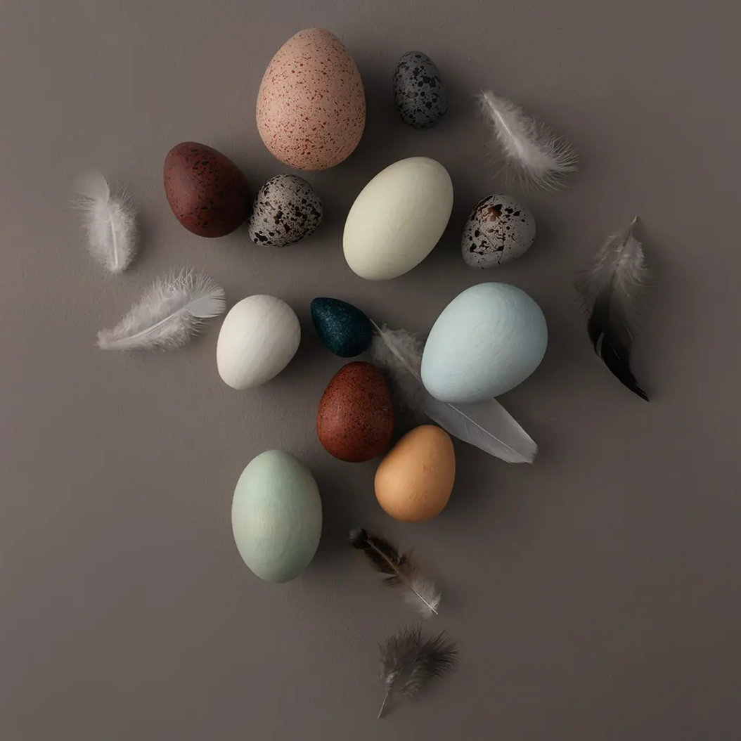 A Dozen Wooden Bird Eggs in a Basket