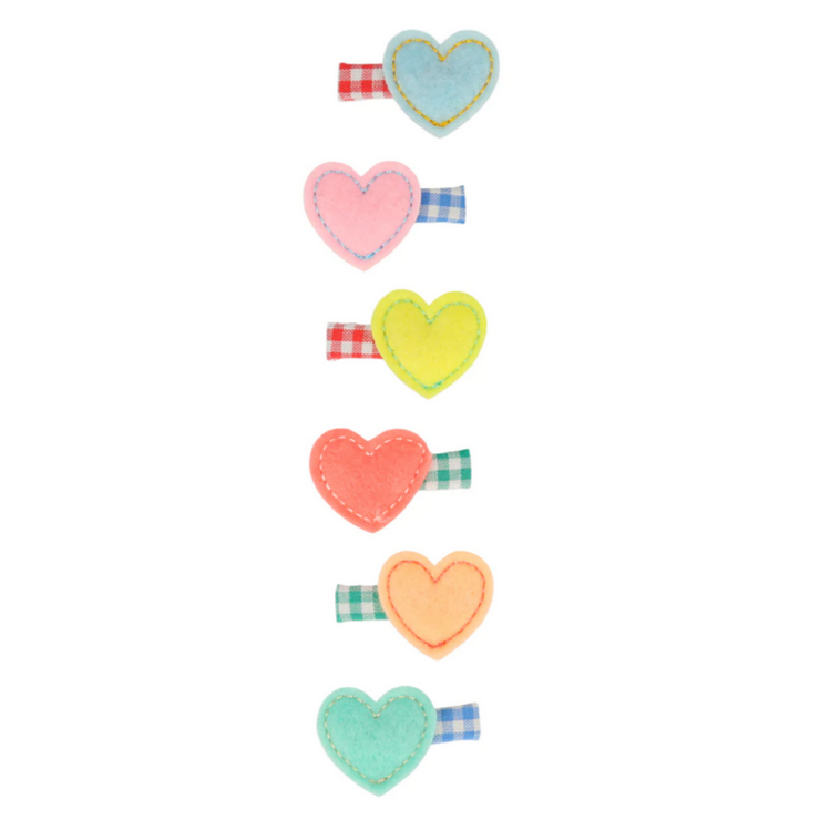 A set of six heart-shaped hair clips in various colors including pink, blue, neon pink, yellow, mint, and peach, each with a felt heart design and a gingham fabric detail.