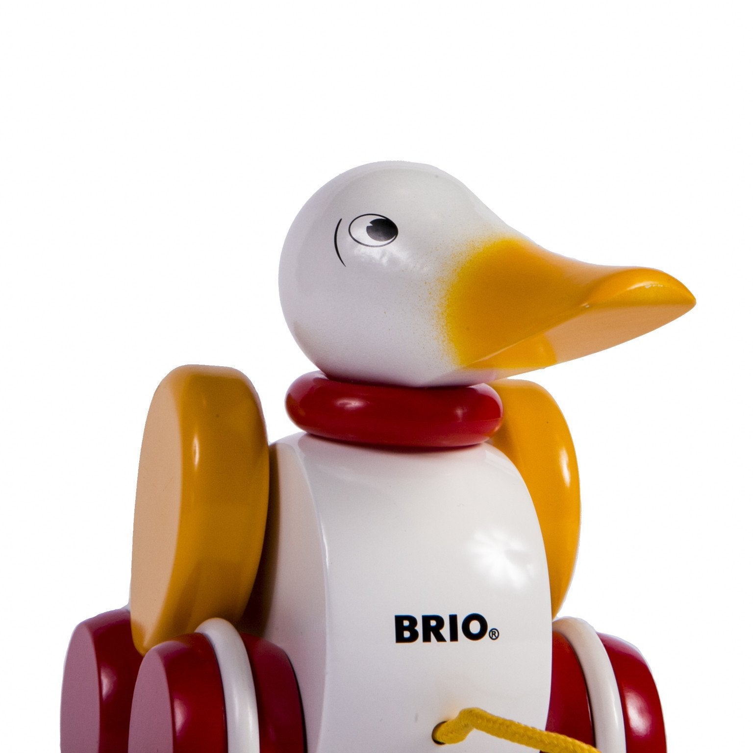 close up of wooden yellow, white and red pull along duck