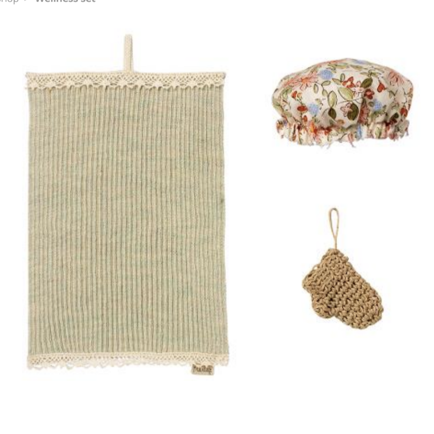 A wellness set for dolls including a towel, a bathing hat, and a bath mitten, with lace details on the towel and a floral pattern on the hat.