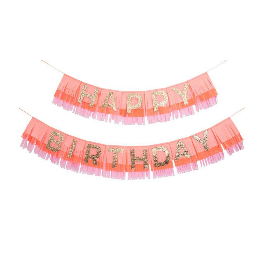 pink fringe garland with golden glitter letters that spell Happy birthday