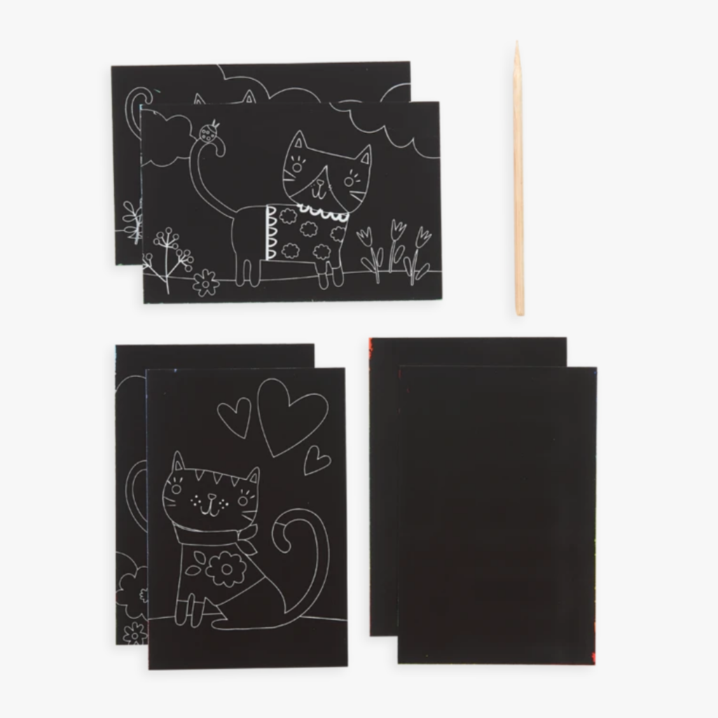 showing black pages with drawings of cats and wooden scratching stick