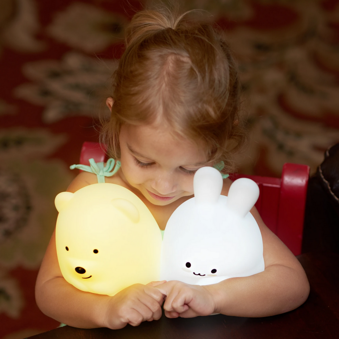 child holding two animal lamps