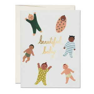 white card with babies and gold cursive text