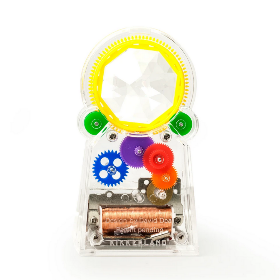A solar-powered rainbow maker toy with multicolored gears and a clear crystal piece, placed on a white background.