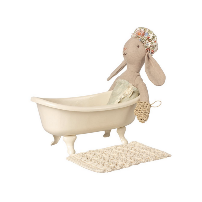 white claw foot bathtub with bath mat and bathing bunny