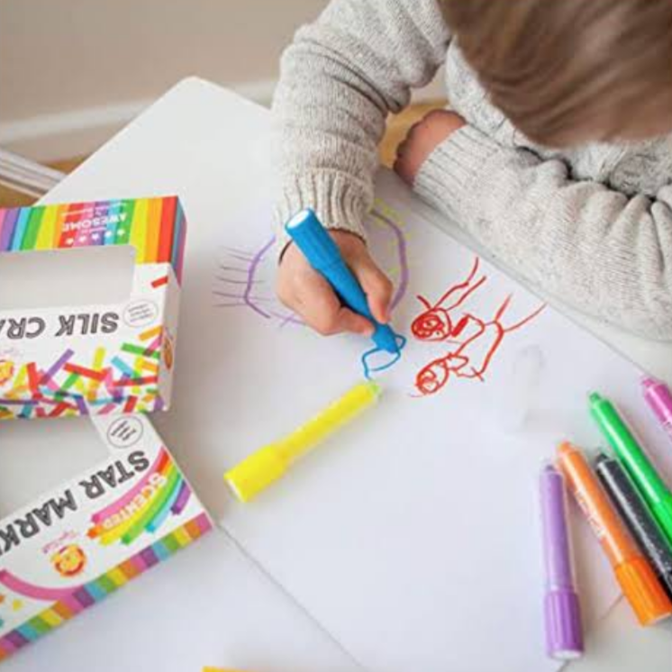 child drawing with crayons
