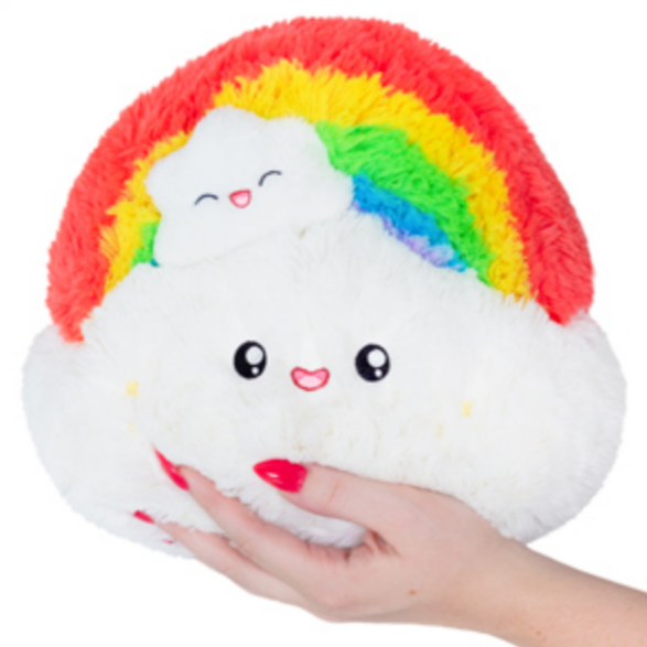 hand holding rainbow plush toy