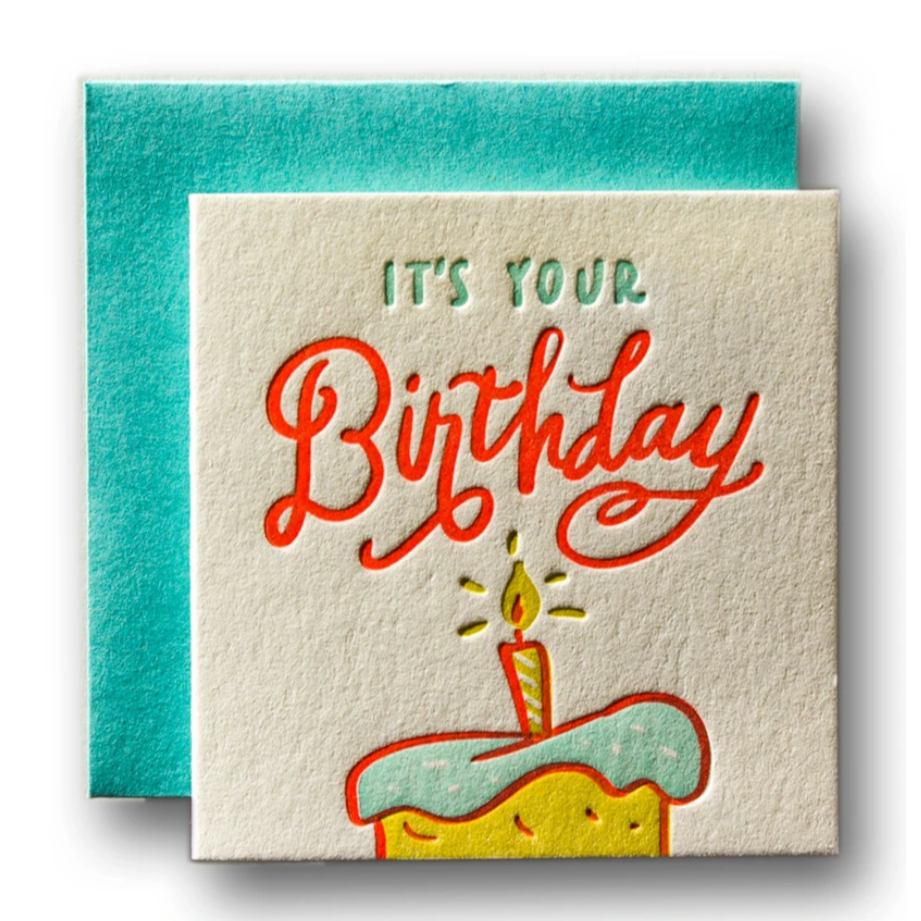 ILLUSTRATION OF A CAKE WITH A CANDLE AND 'ITS YOUR BIRTHDAY' WRITTEN ABOVE