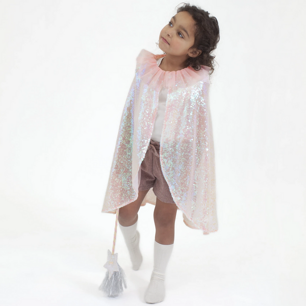 little girl standing wearing pink sequined cape with pink tulle collar with white star wand with silver tassle