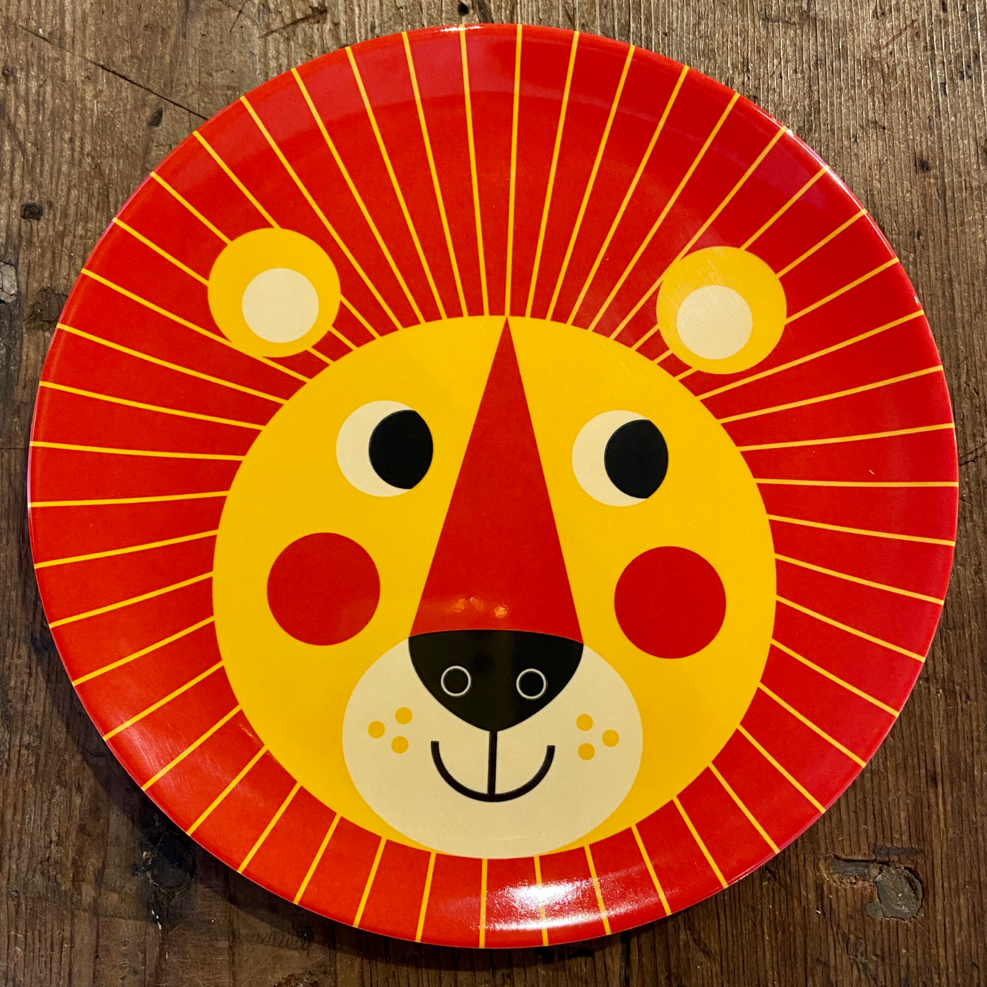 orange and yellow lion face on plate