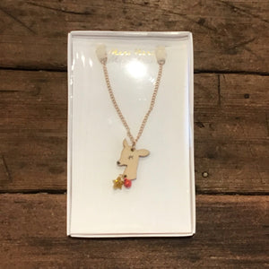 Wooden deer necklace with a tiny golden star and tiny red bell in box