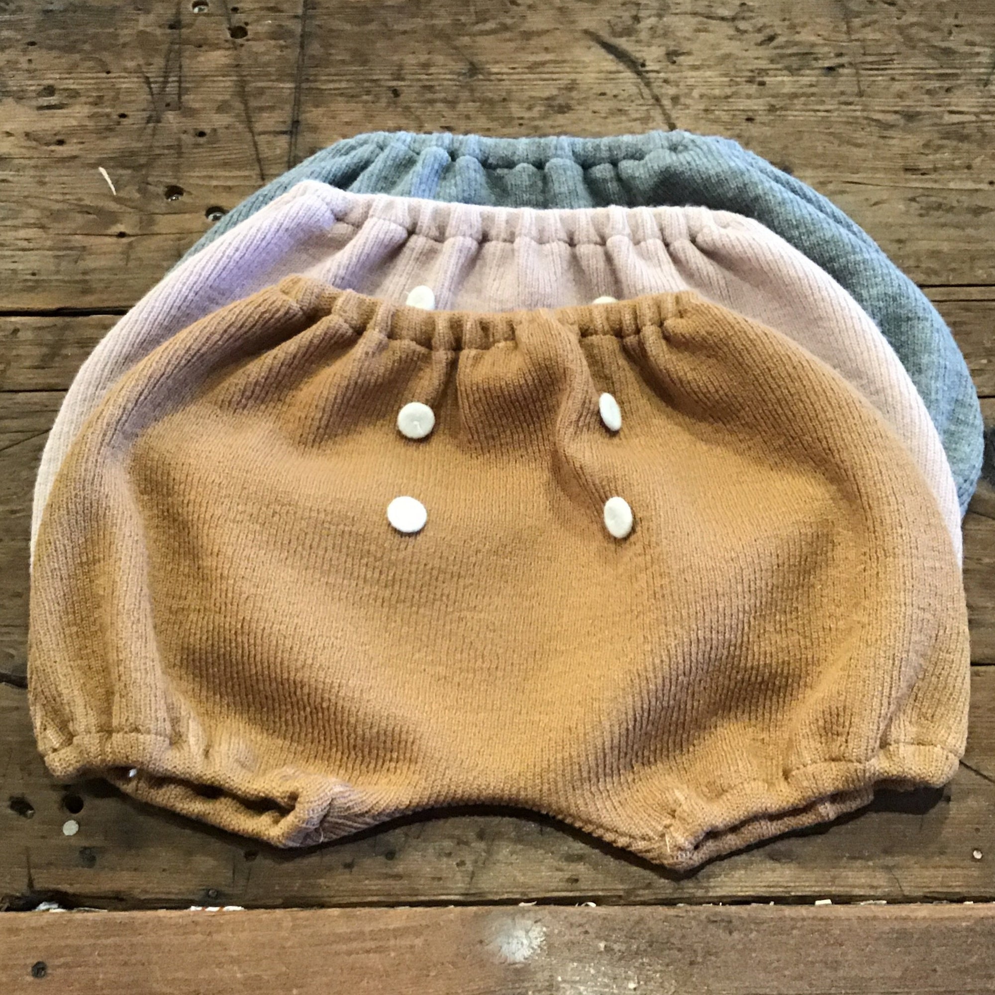 three knit bloomers with four white buttons
