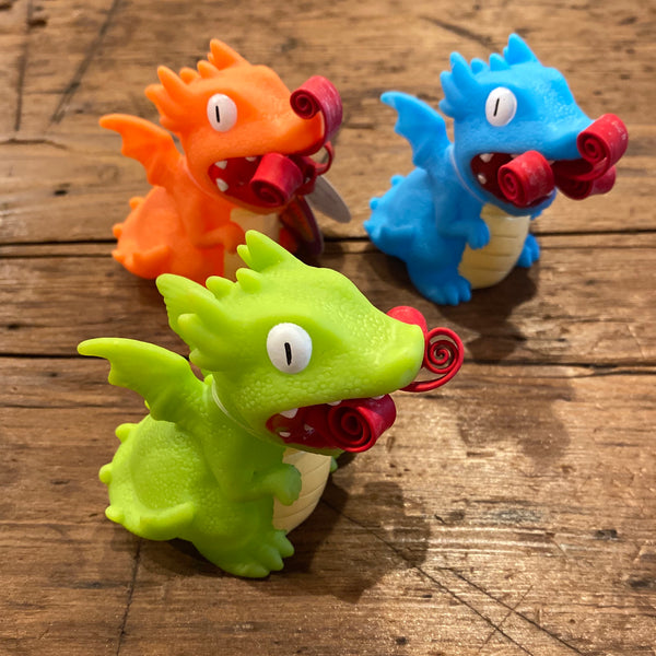 top view of orange, blue and green dragons with curled up fire in mouths