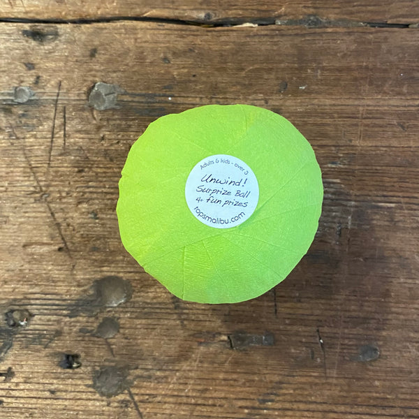 sticker on bottom of light green surprize balls that say "unwind! Surprize ball 4 fun prizes