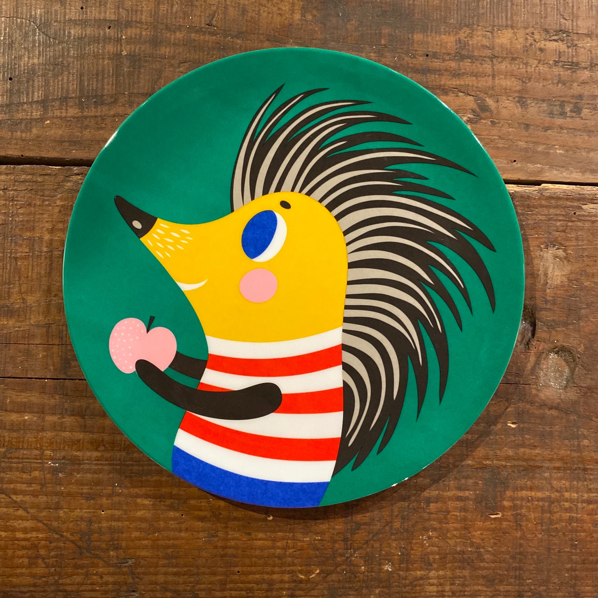 green plate with hedgehog and apple