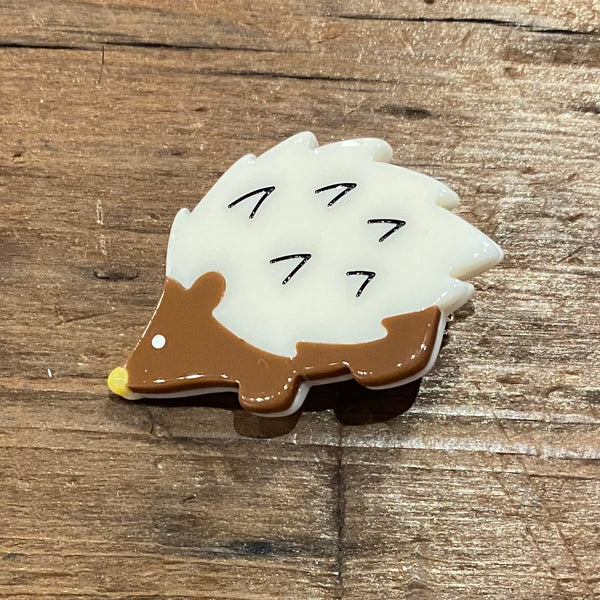brown and white plasic hedgehog hair clip
